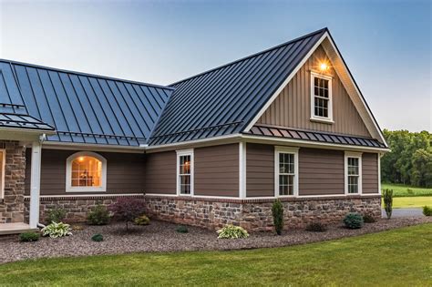 brick and siding house with metal roof|matching brick and roof colors.